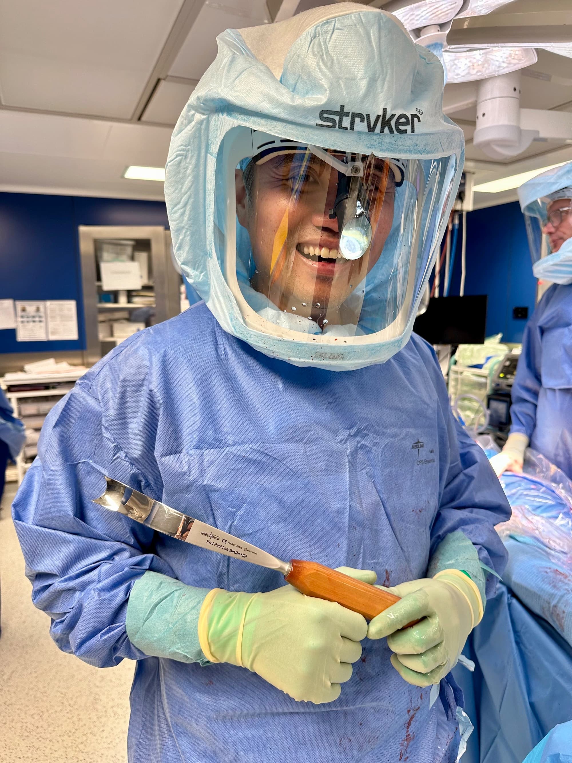 Professor Paul Lee in the operating room wearing surgical PPE.